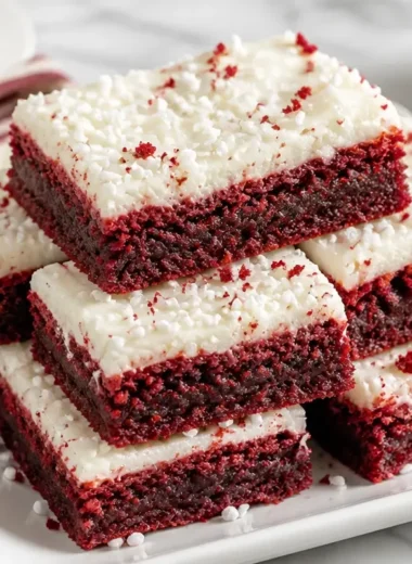Fudgy red velvet brownies made from cake mix, topped with cream cheese icing.