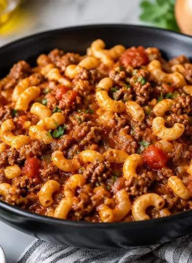 Southern Style Goulash served in a bowl garnished with herbs.